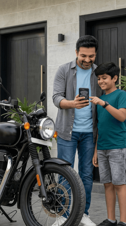 A smiling man and boy view a smartphone together next to a black motorcycle.